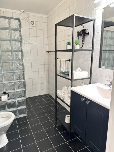 a bathroom with a toilet and a sink at Villa Myklebust in Olden