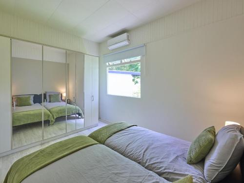 a bedroom with a bed and a mirror at Brabants licht in Lage Mierde