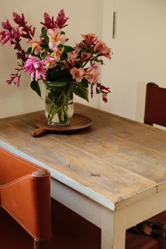 a vase of flowers sitting on top of a table at HeartStone Hill - Studio in Castlemaine