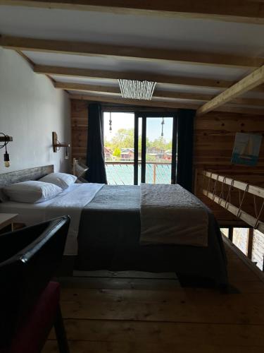 a large bed in a room with a large window at Meris in Ulcinj
