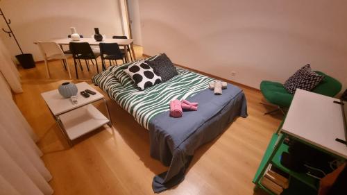 a room with a bed and a table and chairs at Horta Joy! in Horta