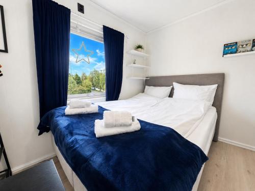 a bedroom with a large bed with towels on it at KB - Villa sentrum Leknes in Vestvågøya
