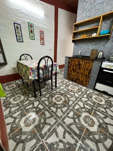 a kitchen with a table and chairs and a stove at Monoambiente LPS in Santiago del Estero