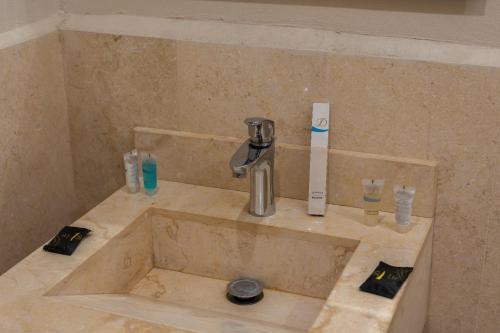 a sink in a bathroom with a faucet at Liora Inside Al Dana beach Resort in Half Moon Bay