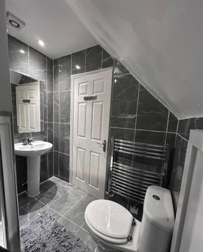a bathroom with a toilet and a sink at New Haven Atherton Greater Manchester in Atherton