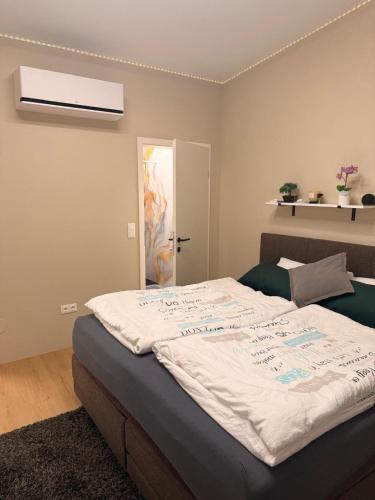 a bedroom with a large bed with a white comforter at Privatroom for rent in Bad Fischau