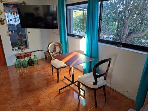a dining room with a table and two chairs at Geranio Bed & Breakfast in Casablanca