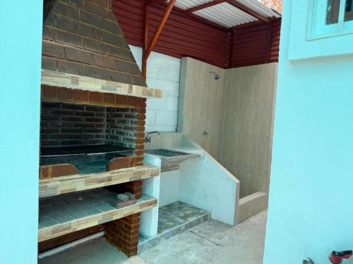 a outdoor shower with a brick fireplace in a house at Cabaña Mar Olon Renovation in Olón