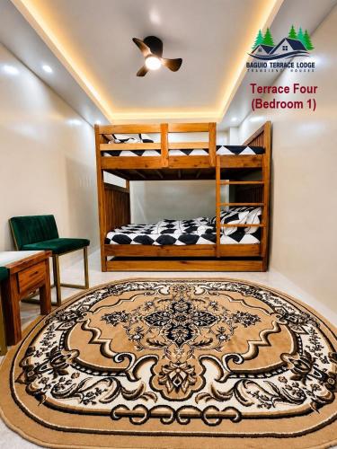a room with two bunk beds and a rug at Baguio Terrace Lodge in Baguio
