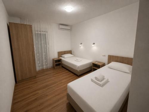 a hotel room with two beds and a window at Sobe Ivan-Popić in Međugorje