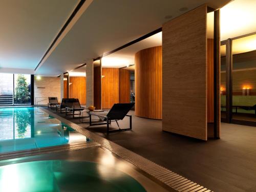 een huis met een zwembad en een woonkamer bij Sense Hotel Sofia, a Member of Design Hotels in Sofia