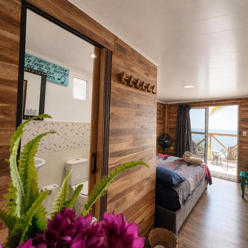 a bedroom with a bed and a large mirror at Freedom Beach Club in Barú