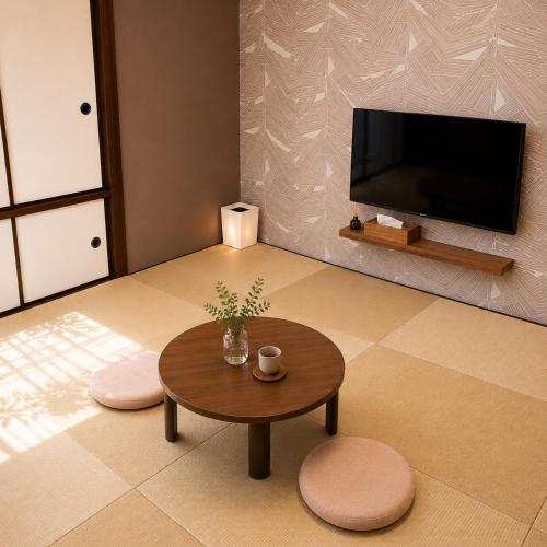 a living room with a coffee table and a flat screen tv at WinGoodDays in Kumamoto