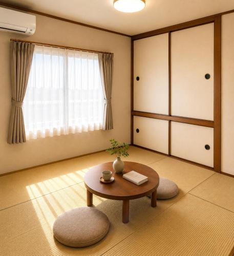 a living room with a table and a window at WinGoodDays in Kumamoto