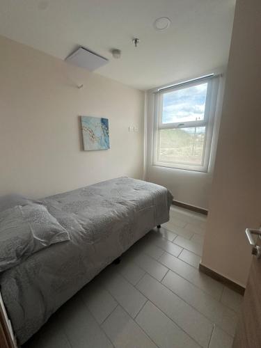 a bedroom with a bed and a window at Angies Loft in Tegucigalpa