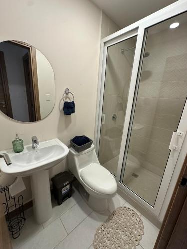 a bathroom with a toilet and a sink and a shower at Angies Loft in Tegucigalpa