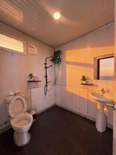 a bathroom with a toilet and a sink at ชาร์จแบต ภูทับเบิก in Ban Muang Baeng