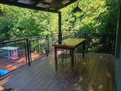 a wooden table and a chair on a deck at Siempre verde3 in Merlo