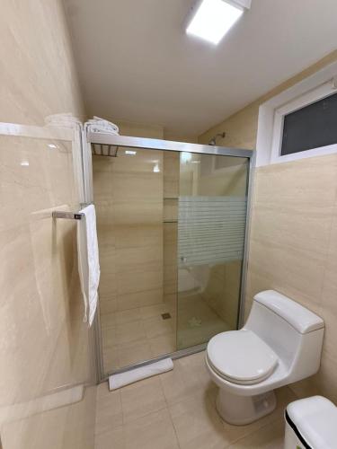 a bathroom with a toilet and a glass shower at Apartamento en Pampatar in Pampatar