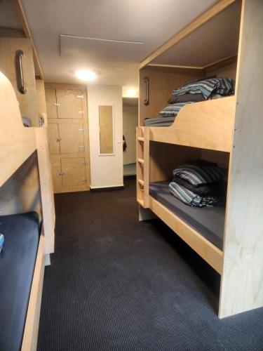 a room with two bunk beds in a train at Aspen Lodge Backpackers in Queenstown