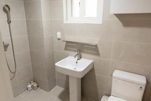 a bathroom with a sink and a toilet and a shower at Danchu stay in Seoul