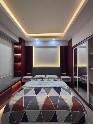 a bedroom with a large bed and a window at Altuz Apartment Seturan Yogyakarta in Seturan