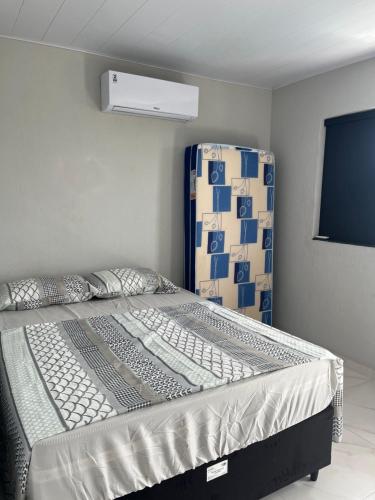 a large bed in a room with avertisement at Suites no Atalaia in Salinópolis