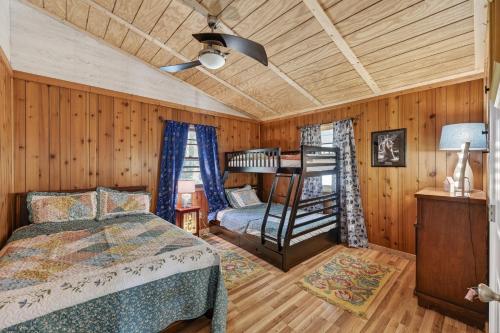 a bedroom with a bed and a chair in a room at Covea Cabin in Luray