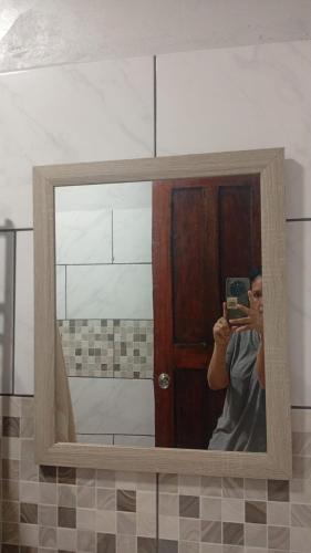a man taking a picture of himself in a mirror at Arbis Jusseth Home in Calobrito
