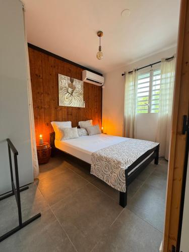 a bedroom with a large bed in a room at Chalet du Soleil in Pointe-Noire