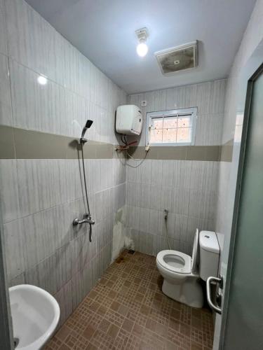 a bathroom with a toilet and a sink at new pratama in Sampal 2