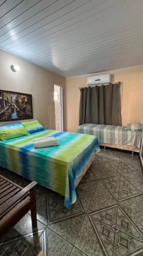 a bedroom with a large bed and a couch at cantinhoannajullyaatins in Atins