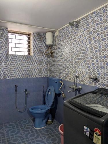 a bathroom with a blue toilet and a sink at shivkrupa Guest house in Arambol