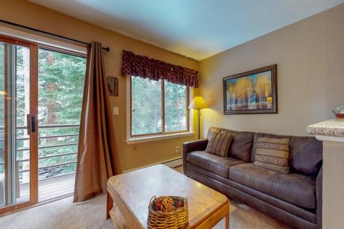 a living room with a couch and a table at Autumn Foliage 209 in Breckenridge