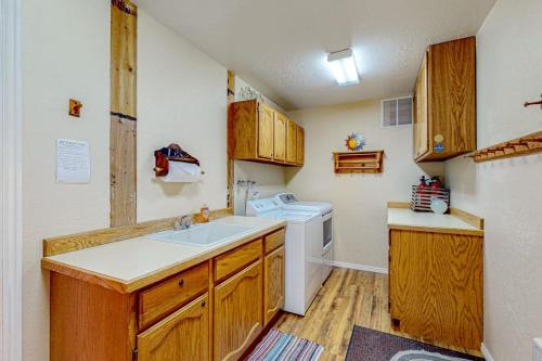 a small kitchen with a sink and a washing machine at Juniper Haven Retreat in Sun Valley