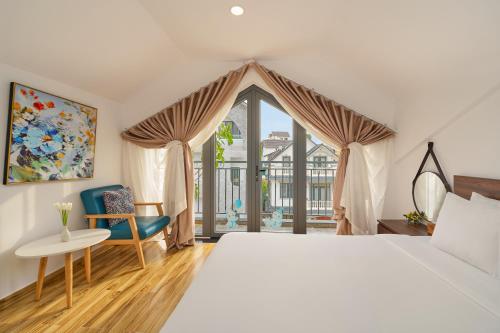 a bedroom with a large bed and a window at KP Villa Dalat in Da Lat