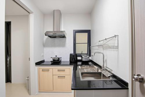 a kitchen with a sink and a counter top at Tiva Residence Bangkok in Bangkok