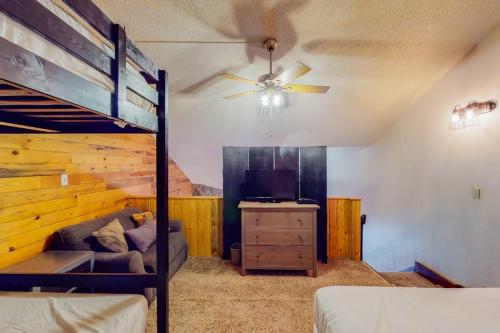 a bedroom with a bunk bed and a couch and a dresser at Silver Lodge A & B in Granby