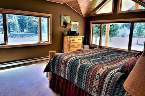 a bedroom with a bed and two windows at Scenic Solitude in South Fork