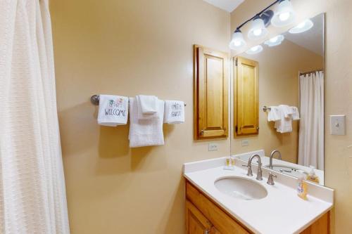 a bathroom with a sink and a mirror at Brown Bear Lodge #322 in Durango Mountain Resort