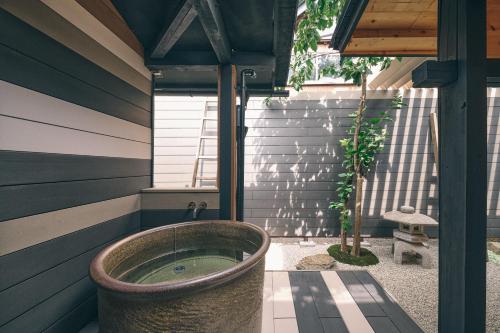 a bath tub in the corner of a house at 御宿 凪ぐ Takayama in Takayama