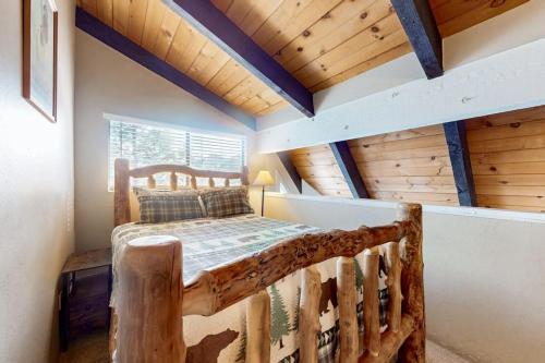 a bedroom with a bed in a room with wooden ceilings at Mammoth View Villas 30 in Mammoth Lakes