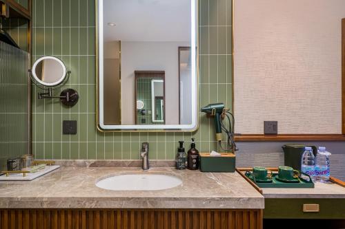 a bathroom with a sink and a mirror at Nostalgia S Hotel Beijing Guomao in Beijing