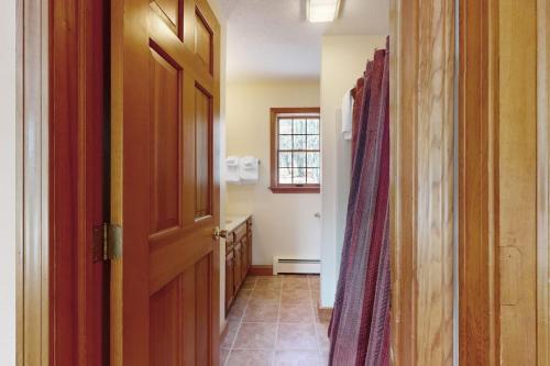 a hallway with an open door to a bathroom at Green Mountain Sunrise in Dover