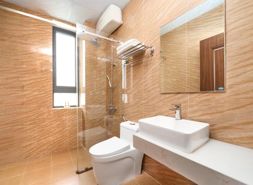 a bathroom with a toilet and a sink and a shower at KP Villa Dalat in Da Lat