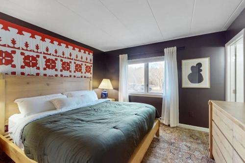 a bedroom with a large bed and a window at 5B Mountain Village- Unit B in Dover