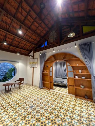 a large room with a stage and a table and chairs at Half Village, Nha Trang in Nha Trang