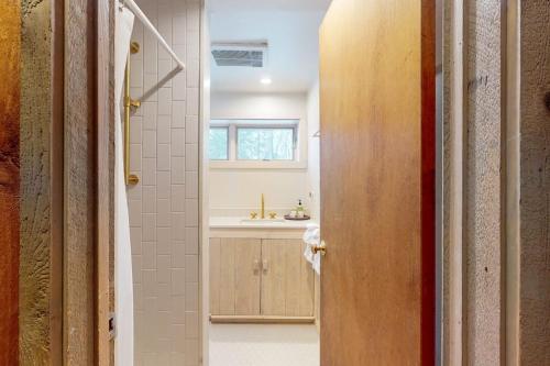 a bathroom with a sink and a toilet in a room at Mad River Masterpiece in Irasville
