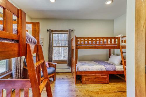 a bedroom with two bunk beds and a window at Lake Rescue Retreat in Ludlow