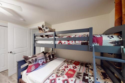 a bedroom with two bunk beds in a room at Magic Birch Lodge in Windham